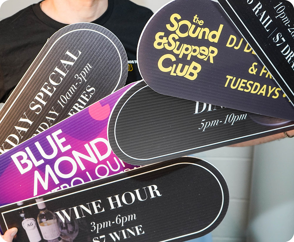 a person holding a group of foam board posters