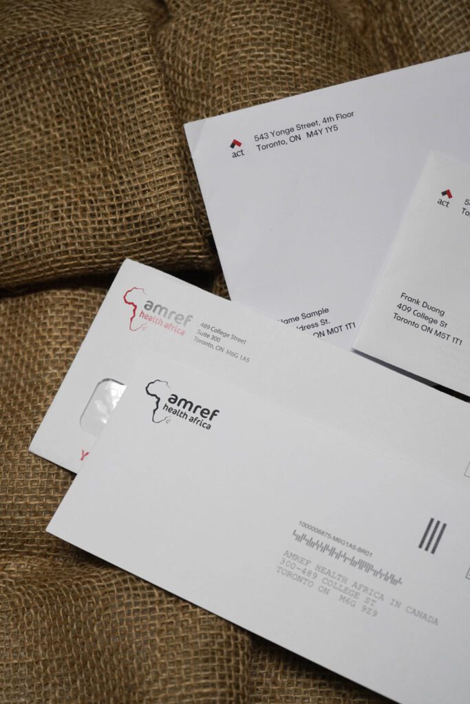 a group of white envelopes on a burlap surface