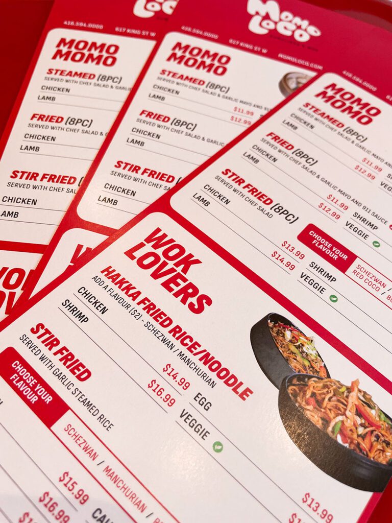 a stack of red and white menus