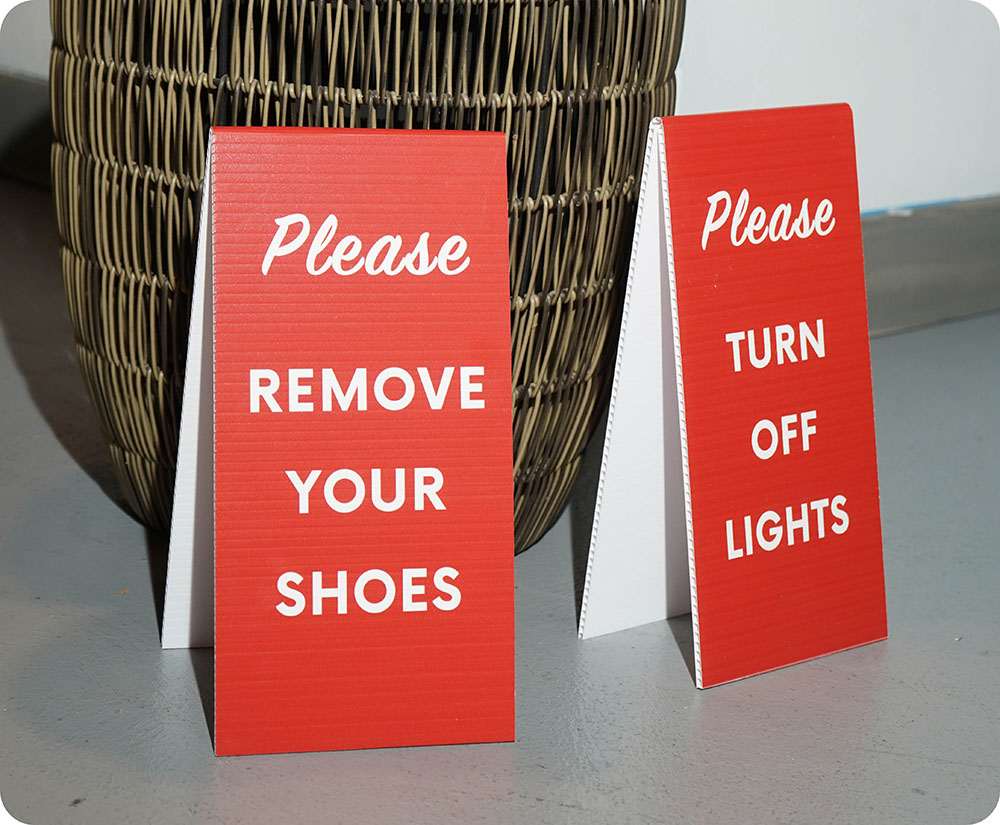 a red and white sign next to a basket