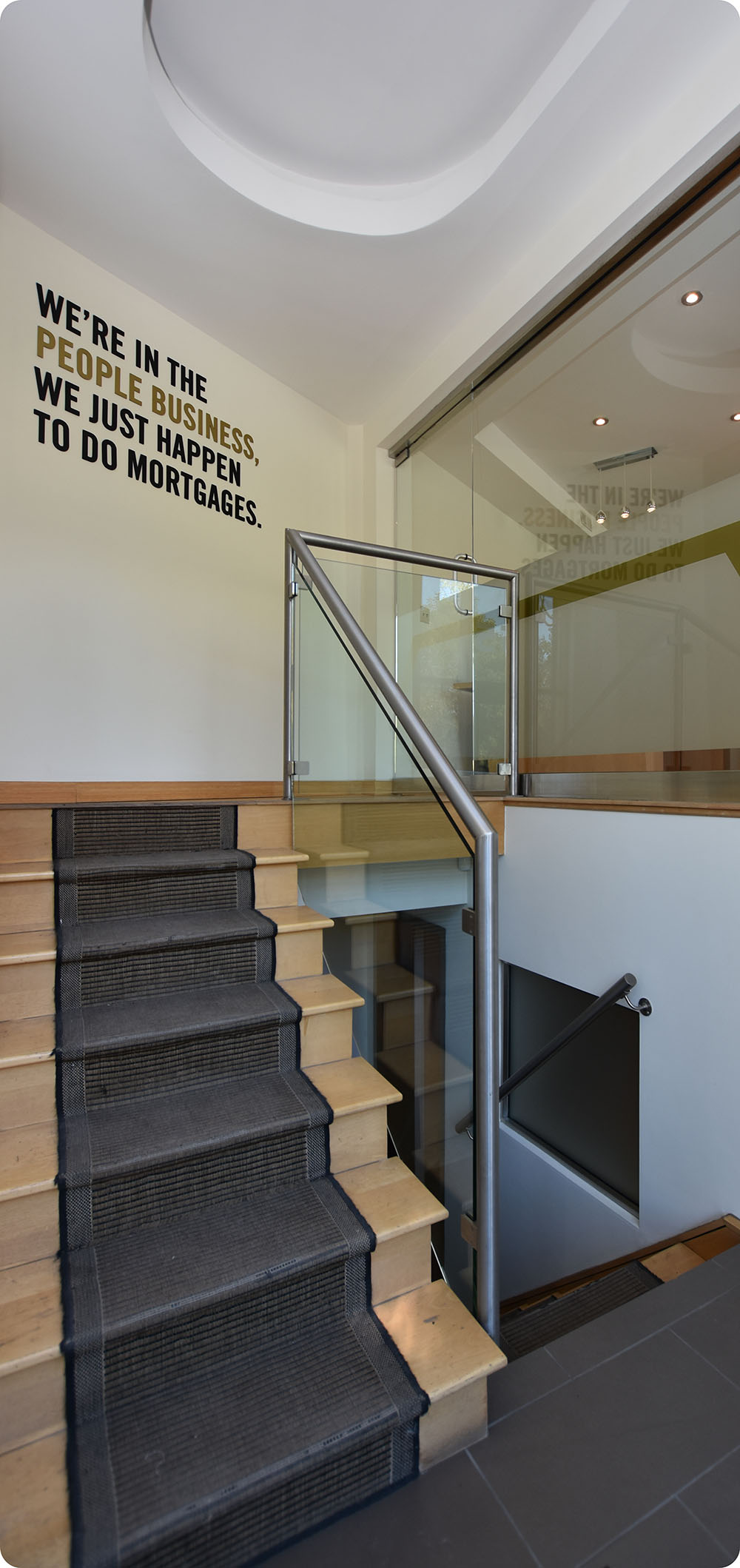 a staircase with glass railing