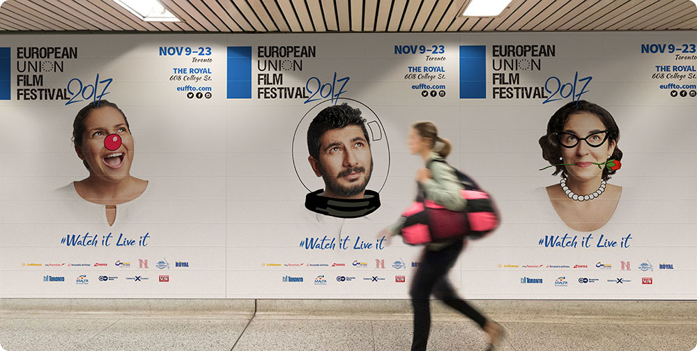 a woman walking past a poster