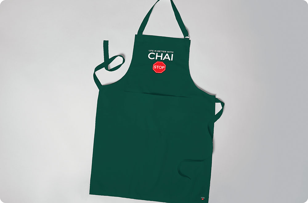 a green apron with a red and white logo