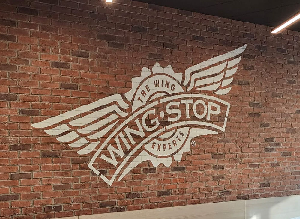 a brick wall with a logo on it